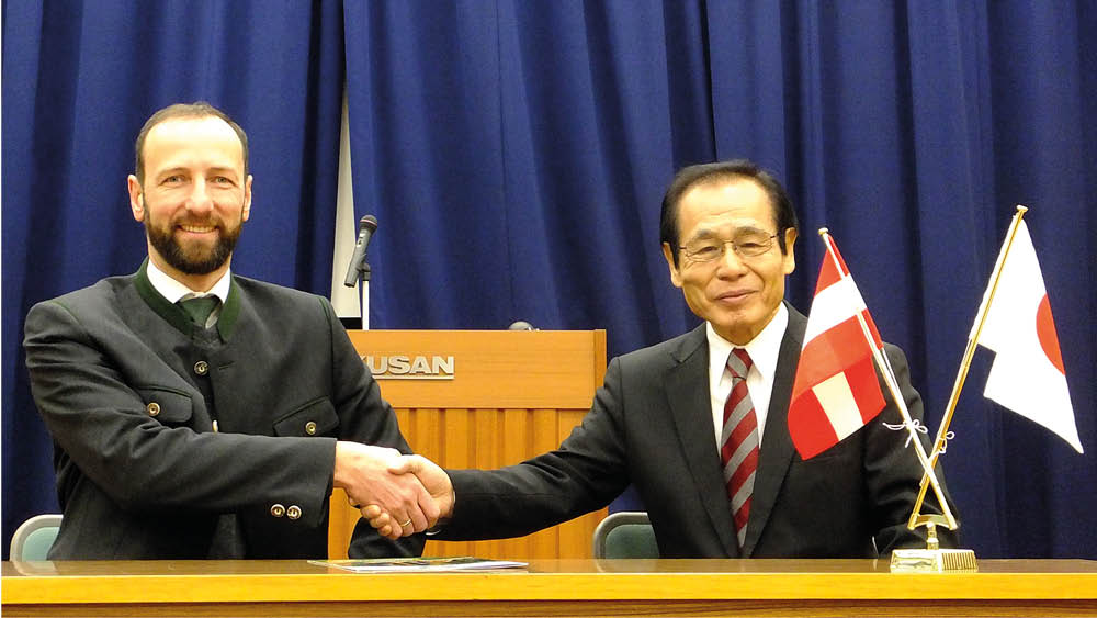 Handshake zwischen Thomas Pusch von MM Forsttechnik und japanischem Partner
